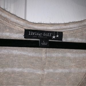 Tan colored stripe top with lace at bottom.